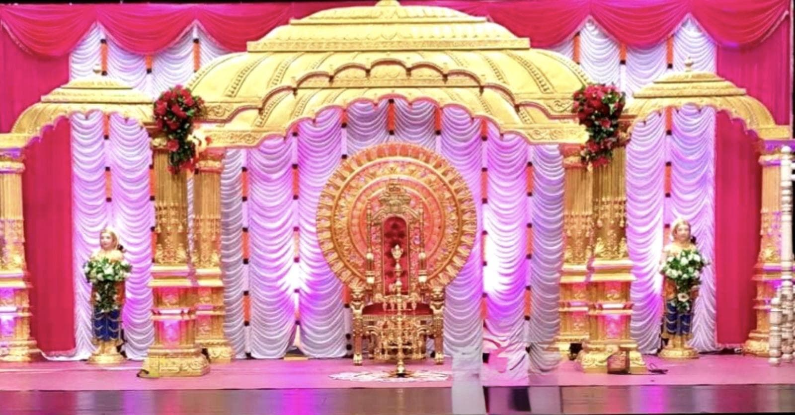 Elegant event hall with table settings and floral decoration.